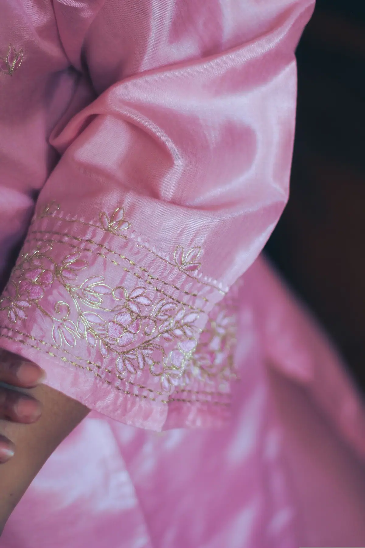 Pink embroidered garment in close detail
