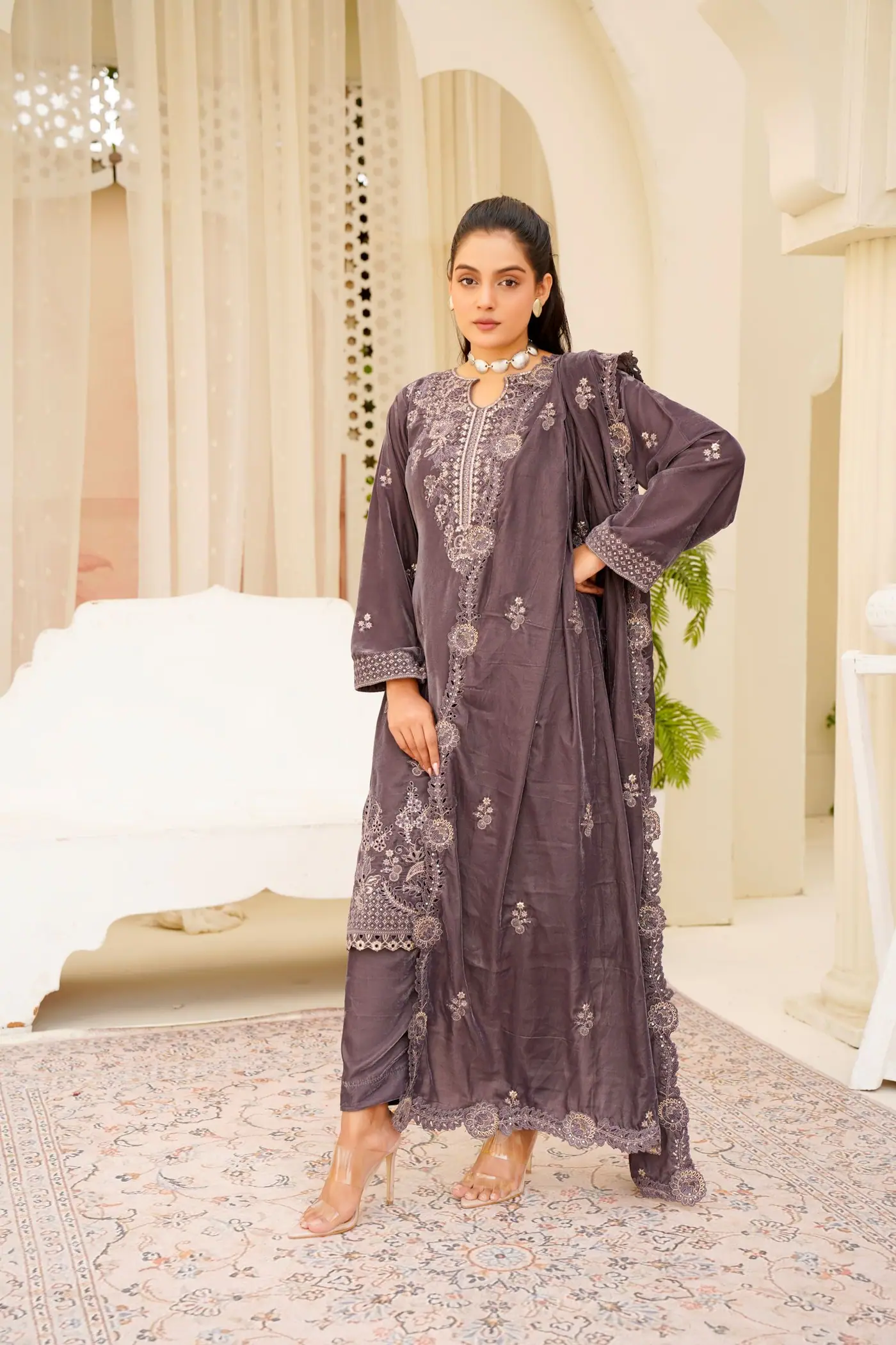 Woman wearing a purple embroidered Pakistani suit